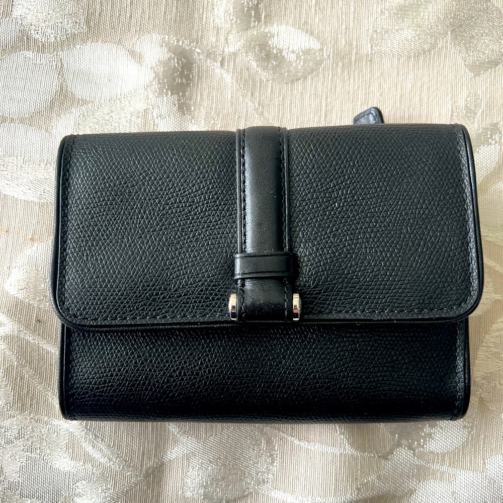 Small trifold black Tumi wallet